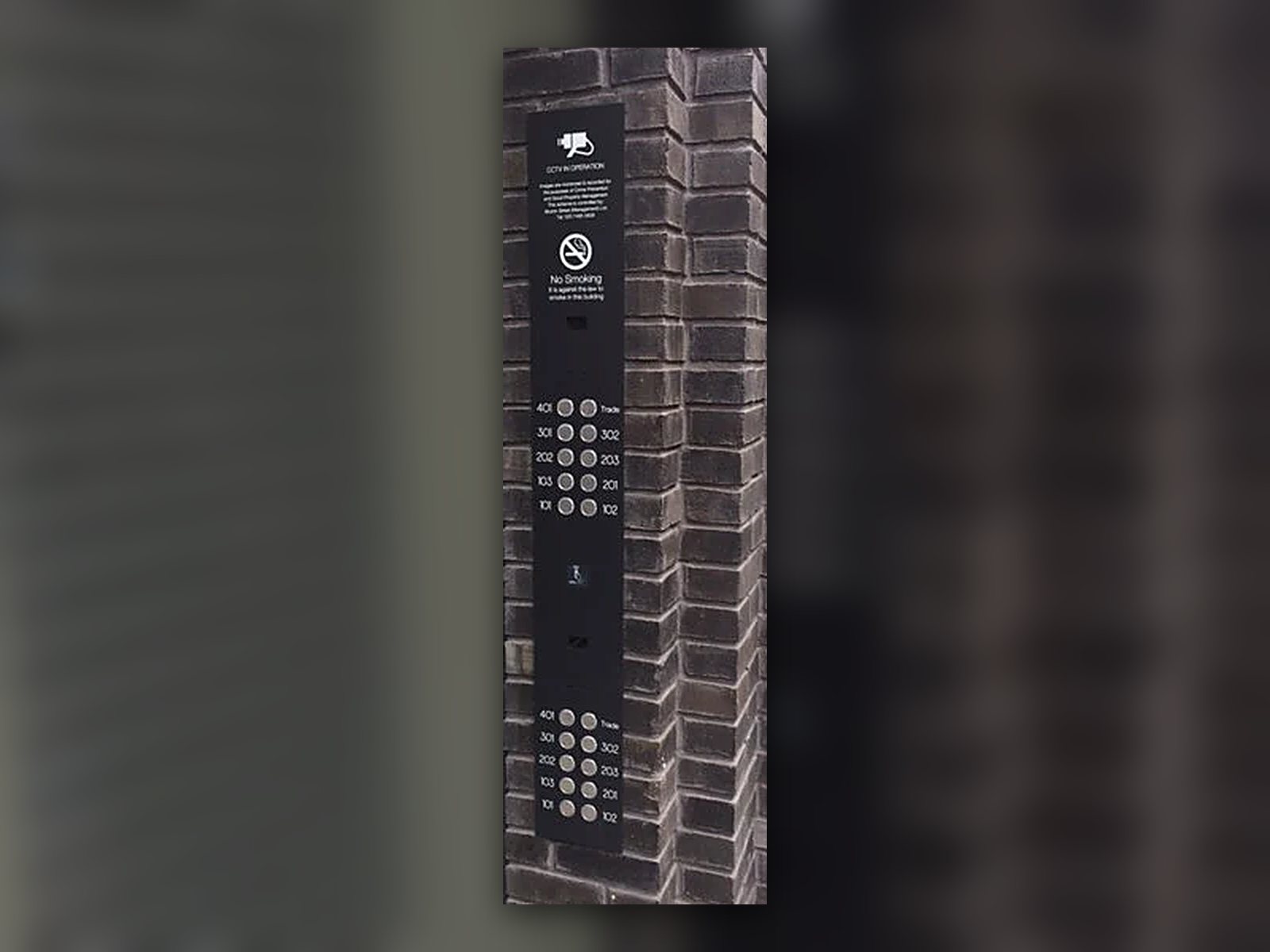 Bespoke black entryphone panel with flat by flat call buttons at Corner House, Fitzrovia