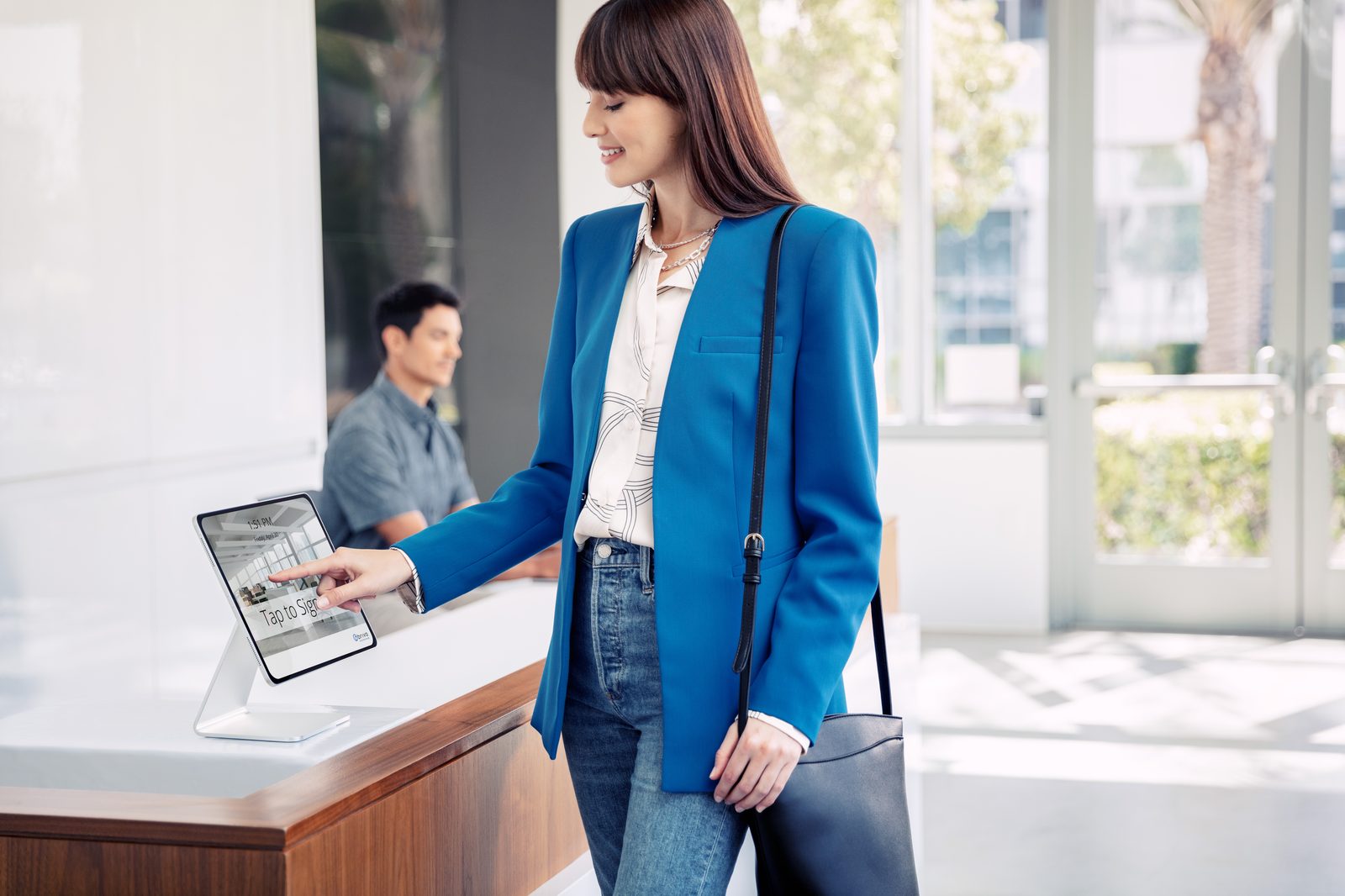 Visitor checking in on a reception tablet